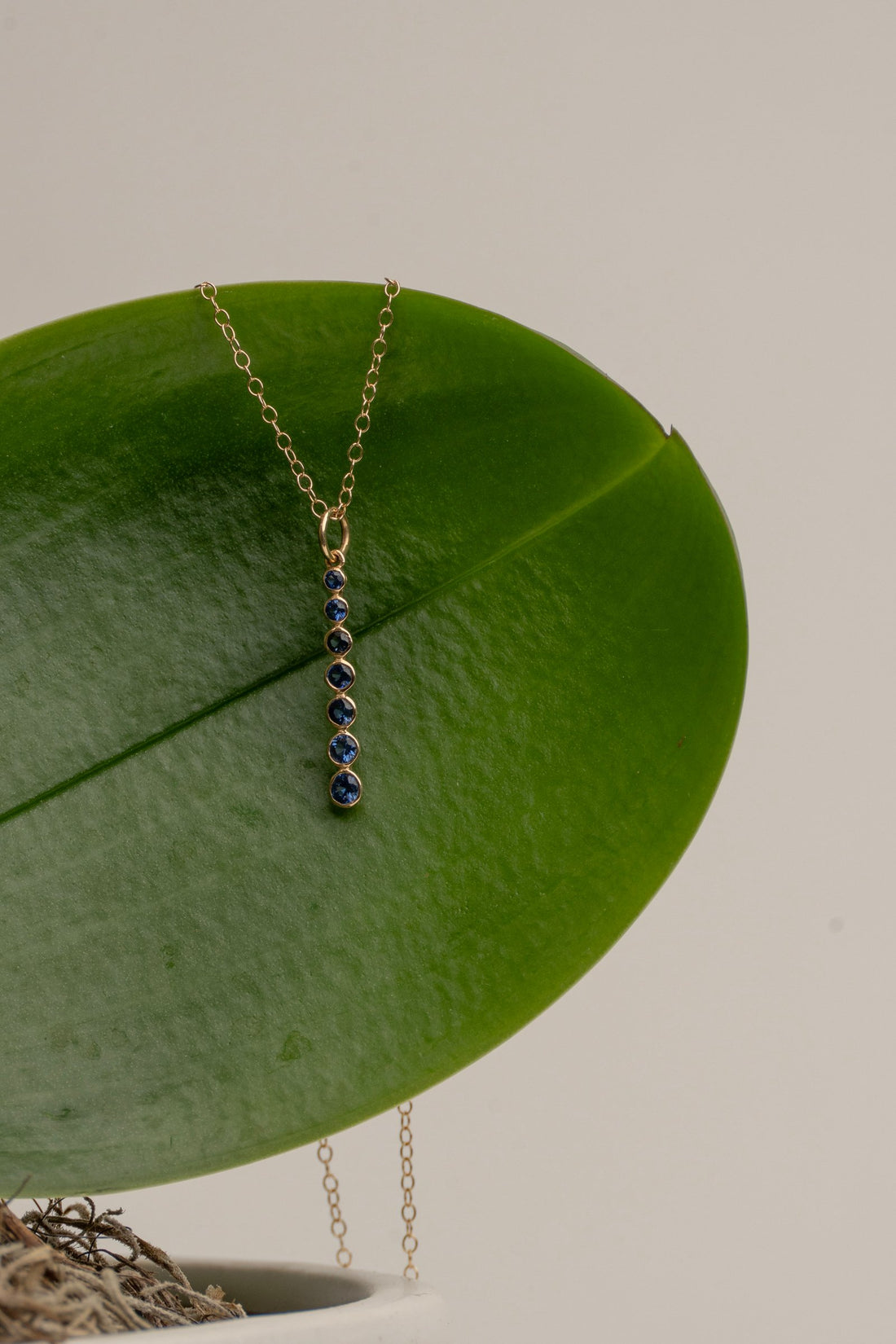7- Bezel Set Sapphires set in 14 Kt. Gold Column on a Delicate Gold Chain
