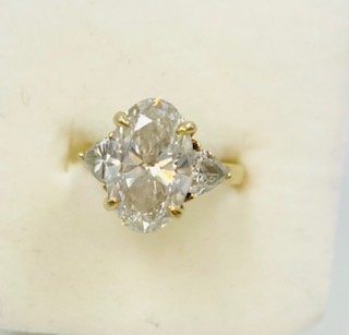 5.02 CtTW- 4 Ct -Elongated Oval Diamond Center with 2-.5 Ct Trillion Side Stones set in 18kt Gold