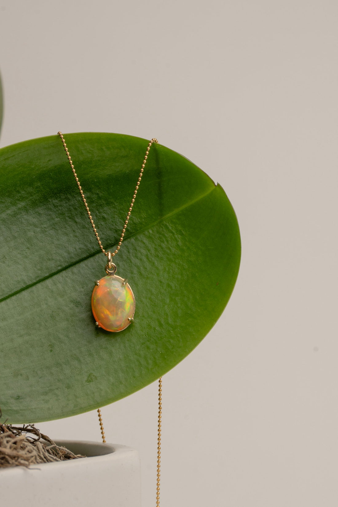 Cab set Fire Opal in a 14kt Gold Setting on a 16" Gold Bead Chain