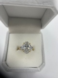 5.02 CtTW- 4 Ct -Elongated Oval Diamond Center with 2-.5 Ct Trillion Side Stones set in 18kt Gold