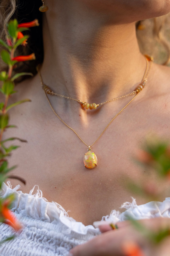 Cab set Fire Opal in a 14kt Gold Setting on a 16" Gold Bead Chain