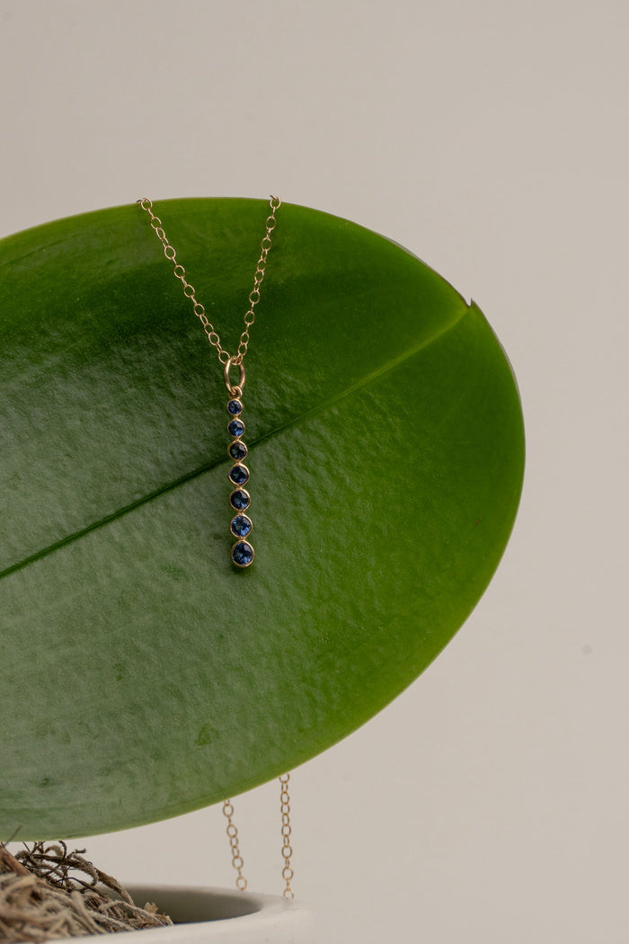 7- Bezel Set Sapphires set in 14 Kt. Gold Column on a Delicate Gold Chain
